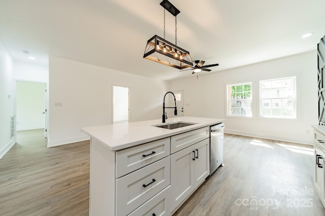 322 S Hill St, Gastonia, NC 28052 - kitchen featuring a sink, light wood finished floors, light countertops, and dishwasher