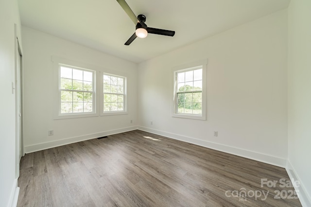 322 S Hill St, Gastonia, NC 28052 - spare room with baseboards, visible vents, ceiling fan, and wood finished floors