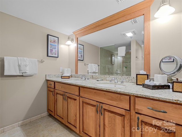 bathroom with a stall shower, tile patterned flooring, vanity, and baseboards
