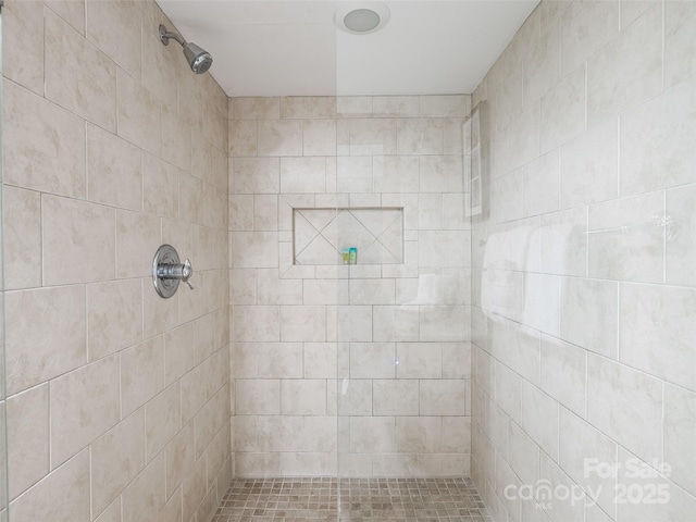 full bath featuring tiled shower
