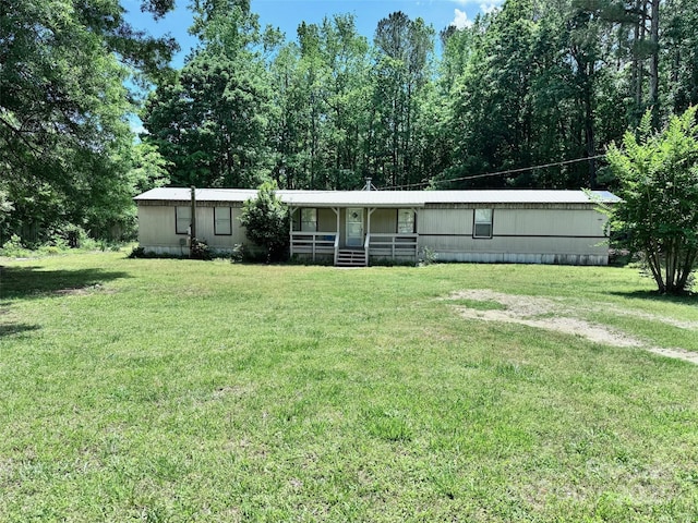 manufactured / mobile home with a front lawn and covered porch