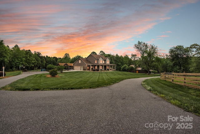 3440 17th Ave NE, Hickory, NC 28601 - new england style home with a front lawn, fence, and curved driveway