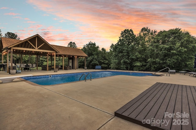 3440 17th Ave NE, Hickory, NC 28601 - pool at dusk with a patio area, a gazebo, a diving board, and an outdoor pool
