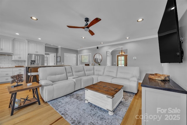 3440 17th Ave NE, Hickory, NC 28601 - living room featuring recessed lighting, ceiling fan, crown molding, arched walkways, and light wood-type flooring