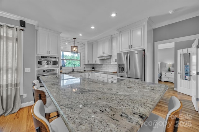 3440 17th Ave NE, Hickory, NC 28601 - kitchen featuring white cabinetry, light wood finished floors, stainless steel fridge, and a sink