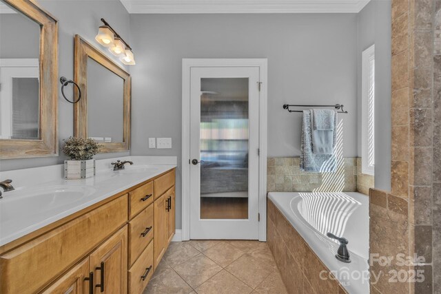 3440 17th Ave NE, Hickory, NC 28601 - bathroom featuring a relaxing tiled tub, a sink, tile patterned floors, crown molding, and double vanity