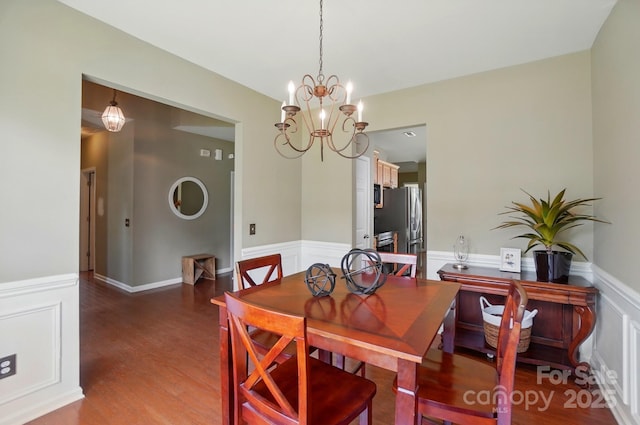 14402 Asheton Creek Dr, Charlotte, NC 28273 - dining space featuring wainscoting, wood finished floors, and a chandelier