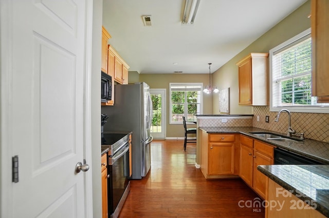 14402 Asheton Creek Dr, Charlotte, NC 28273 - kitchen with stainless steel electric range oven, black microwave, dark wood finished floors, a sink, and backsplash