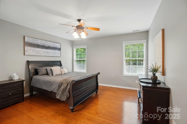 14402 Asheton Creek Dr, Charlotte, NC 28273 - bedroom featuring multiple windows, light wood-style floors, baseboards, and ceiling fan