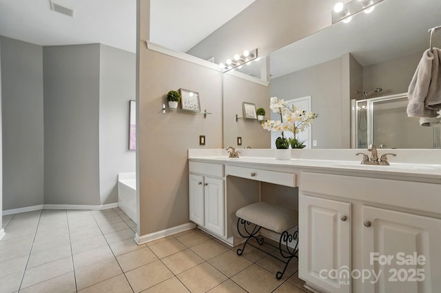 14402 Asheton Creek Dr, Charlotte, NC 28273 - bathroom featuring a stall shower, tile patterned flooring, double vanity, a garden tub, and baseboards
