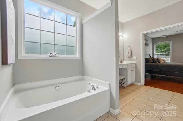 14402 Asheton Creek Dr, Charlotte, NC 28273 - bathroom featuring ensuite bathroom, tile patterned floors, a bath, vanity, and baseboards
