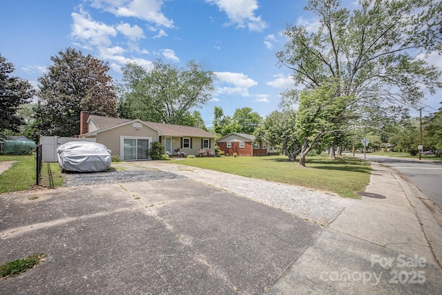 single story home with aphalt driveway and a front lawn