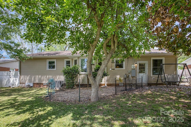 back of property featuring a yard and fence