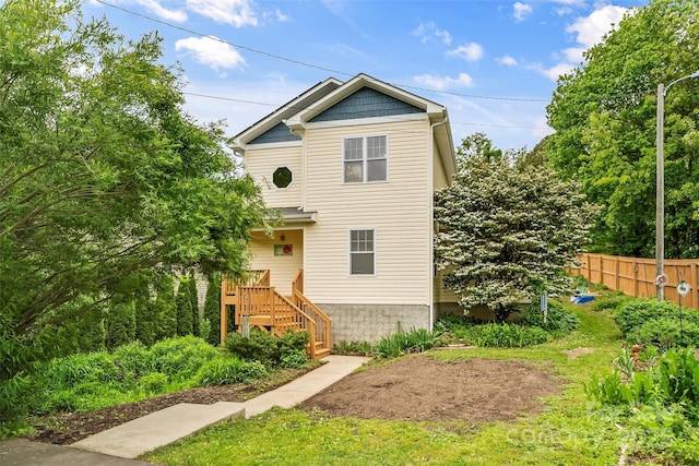 view of front of home featuring fence