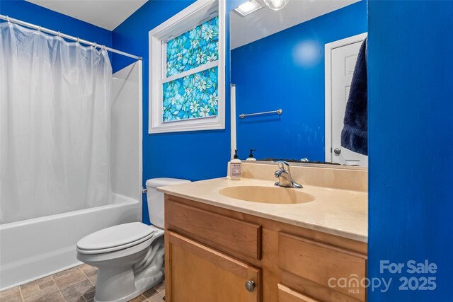 bathroom featuring toilet, shower / bathtub combination with curtain, and vanity