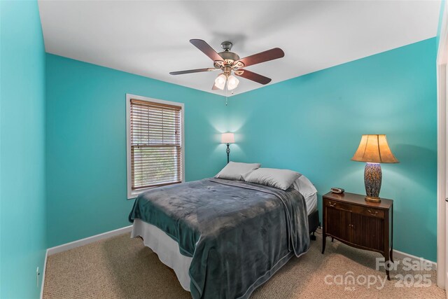 carpeted bedroom with baseboards and a ceiling fan