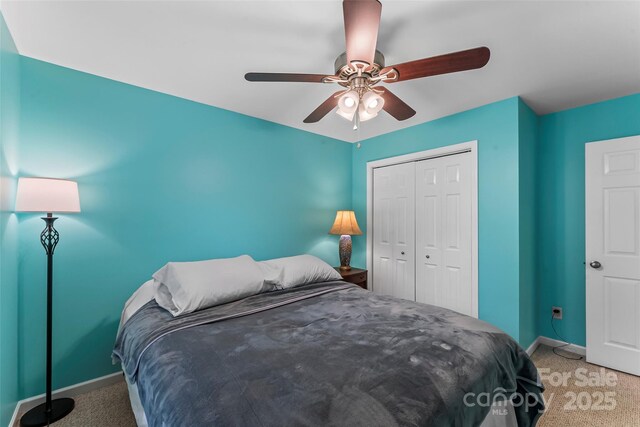 carpeted bedroom featuring baseboards, a closet, and ceiling fan