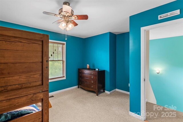 unfurnished bedroom with carpet flooring, baseboards, and ceiling fan