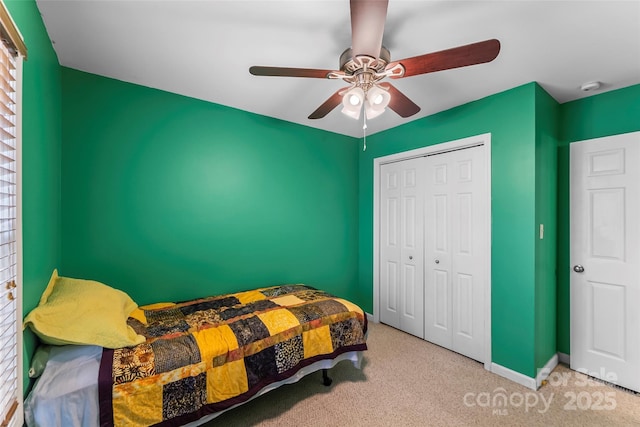 bedroom with carpet flooring, a closet, a ceiling fan, and baseboards