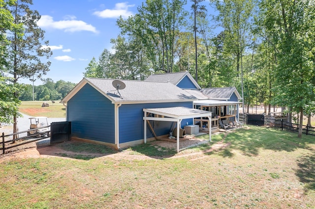 rear view of property featuring roof with shingles