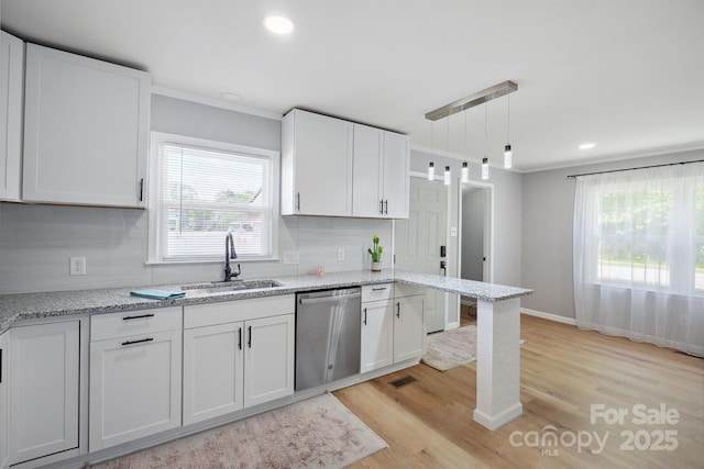 kitchen featuring white cabinetry, ornamental molding, light wood finished floors, and dishwasher