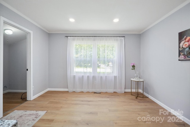 spare room featuring crown molding, wood finished floors, baseboards, and recessed lighting