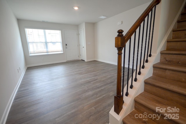 foyer entrance with baseboards, dark wood-style flooring, stairway, and visible vents