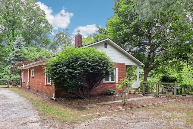 108 Patton Hill Rd, Swannanoa, NC 28778 - view of home's exterior featuring brick siding and a chimney