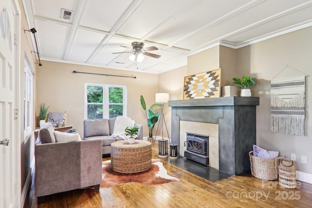 108 Patton Hill Rd, Swannanoa, NC 28778 - living area featuring wood finished floors, a ceiling fan, ornamental molding, and a wood stove