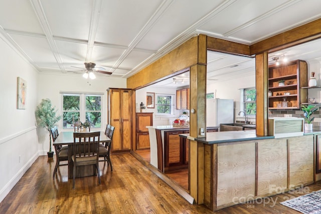 108 Patton Hill Rd, Swannanoa, NC 28778 - kitchen featuring dark wood-style flooring, healthy amount of natural light, ceiling fan, brown cabinets, and crown molding