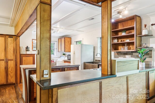 108 Patton Hill Rd, Swannanoa, NC 28778 - kitchen featuring washing machine and clothes dryer, freestanding refrigerator, track lighting, and brown cabinets