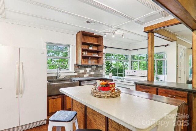 108 Patton Hill Rd, Swannanoa, NC 28778 - kitchen featuring white appliances, a sink, brown cabinets, a kitchen island, and open shelves