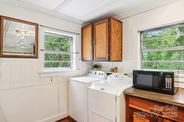 108 Patton Hill Rd, Swannanoa, NC 28778 - laundry area featuring independent washer and dryer, cabinet space, healthy amount of natural light, and a decorative wall