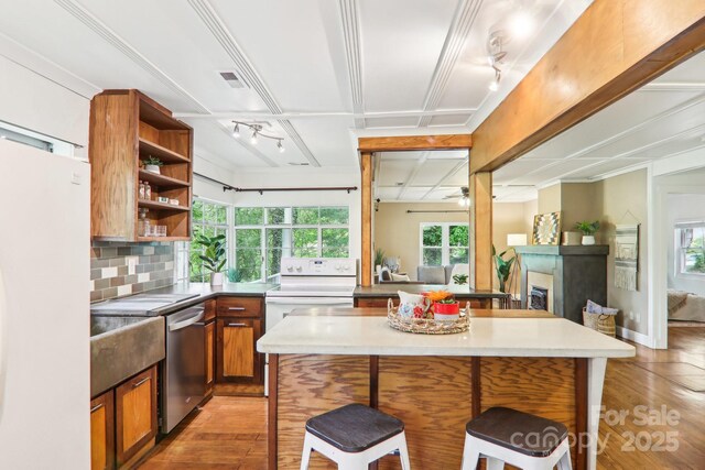 108 Patton Hill Rd, Swannanoa, NC 28778 - kitchen with open shelves, white appliances, track lighting, light wood-style flooring, and a breakfast bar area