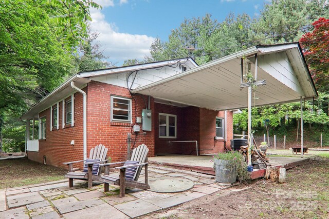 108 Patton Hill Rd, Swannanoa, NC 28778 - rear view of property with a patio area, brick siding, and a carport