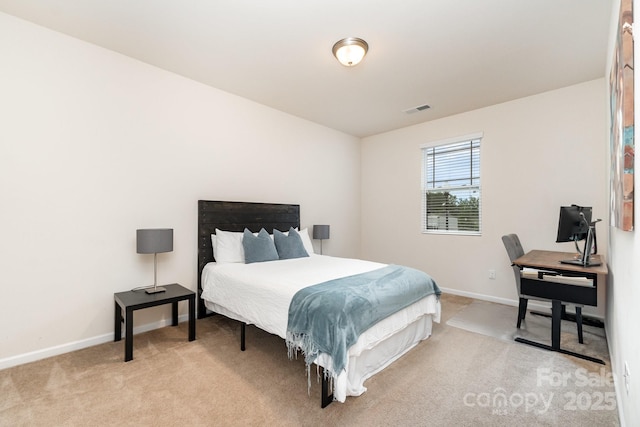 carpeted bedroom with baseboards and visible vents