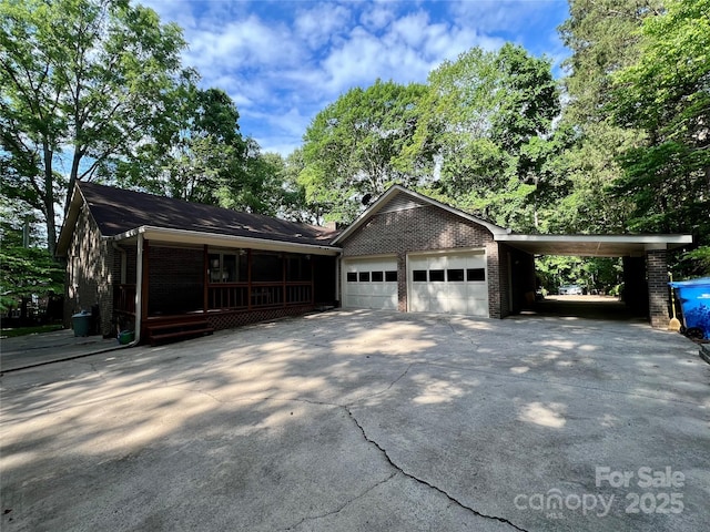 garage featuring driveway and covered porch