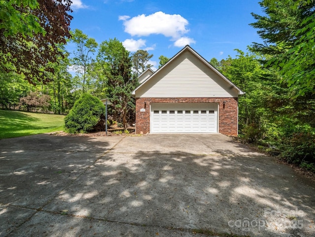 163 Summit Ln, Rutherfordton, NC 28139 - view of side of property featuring concrete driveway, brick siding, and a garage