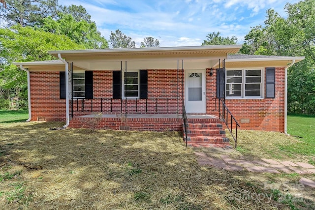 view of front facade featuring crawl space, a porch, and brick siding