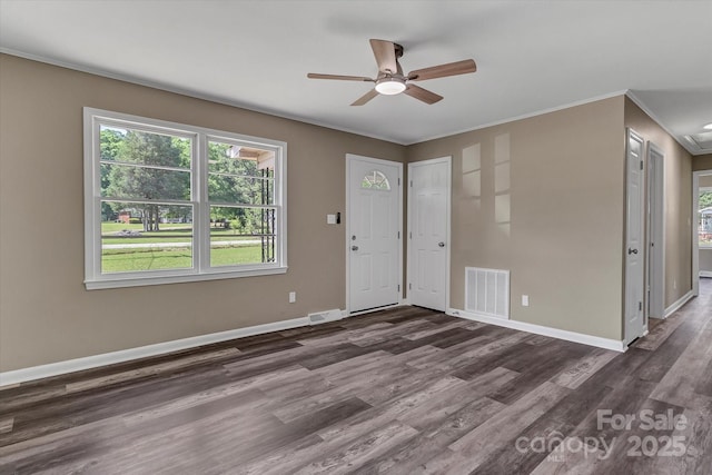foyer entrance with dark wood-style flooring, ceiling fan, baseboards, and crown molding