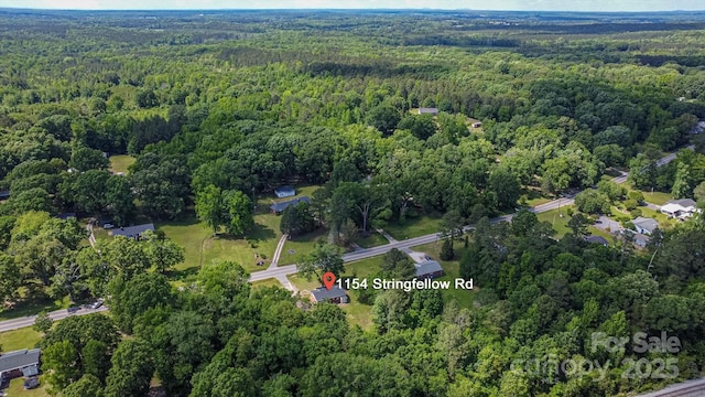 aerial view of property's location with a heavily wooded area