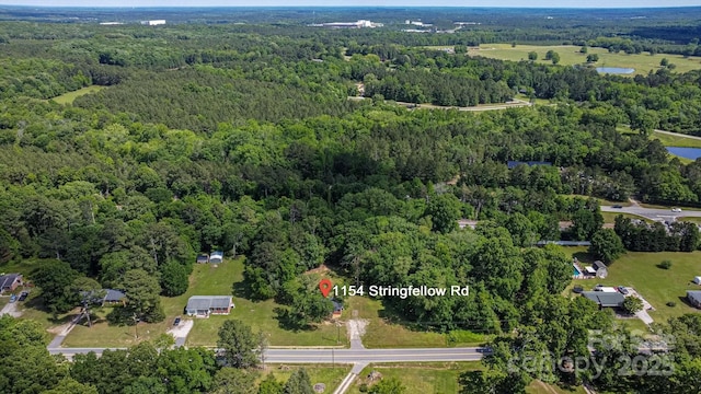 view of property location with a heavily wooded area