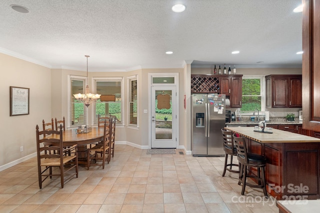 104 Belvedere Dr, Morganton, NC 28655 - dining space featuring ornamental molding, a chandelier, light tile patterned flooring, baseboards, and a textured ceiling