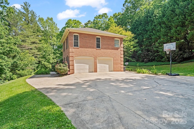 104 Belvedere Dr, Morganton, NC 28655 - view of home's exterior featuring driveway, brick siding, an attached garage, and a lawn