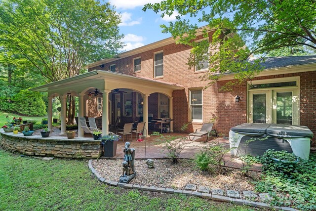 104 Belvedere Dr, Morganton, NC 28655 - back of property featuring a hot tub, ceiling fan, a patio, and brick siding
