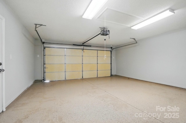garage with a garage door opener and baseboards