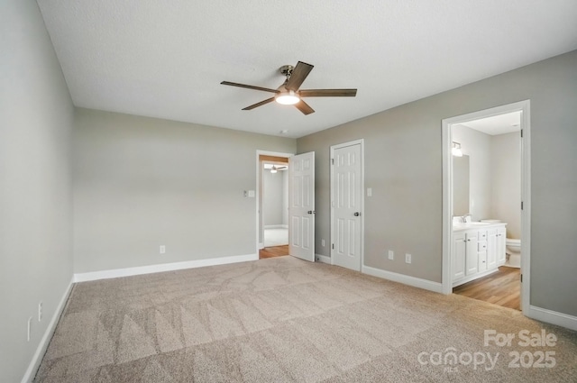 8309 Emily Dr, Harrisburg, NC 28075 - unfurnished bedroom featuring light colored carpet, baseboards, ensuite bath, and a ceiling fan