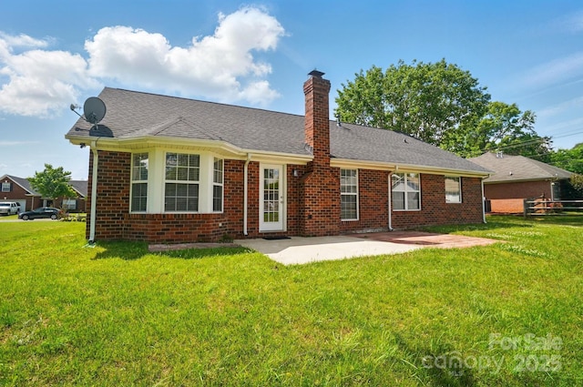 back of property featuring a chimney, a patio area, and brick siding