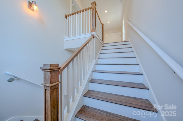 stairs featuring recessed lighting