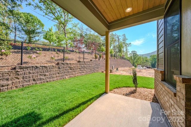 view of patio / terrace with a mountain view and fence
